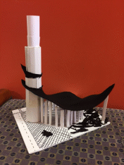 Right view of Liam's structure, a tall foamboard tower connected to smaller rectangular structures of graduated size with a piece of black felt.