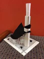 Left view of Liam's structure, a tall foamboard tower connected to smaller rectangular structures of graduated size with a piece of black felt.